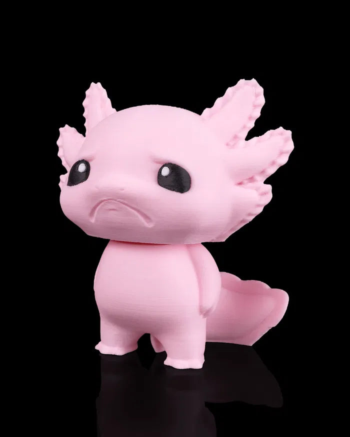 Pink axolotl figurine on a black background