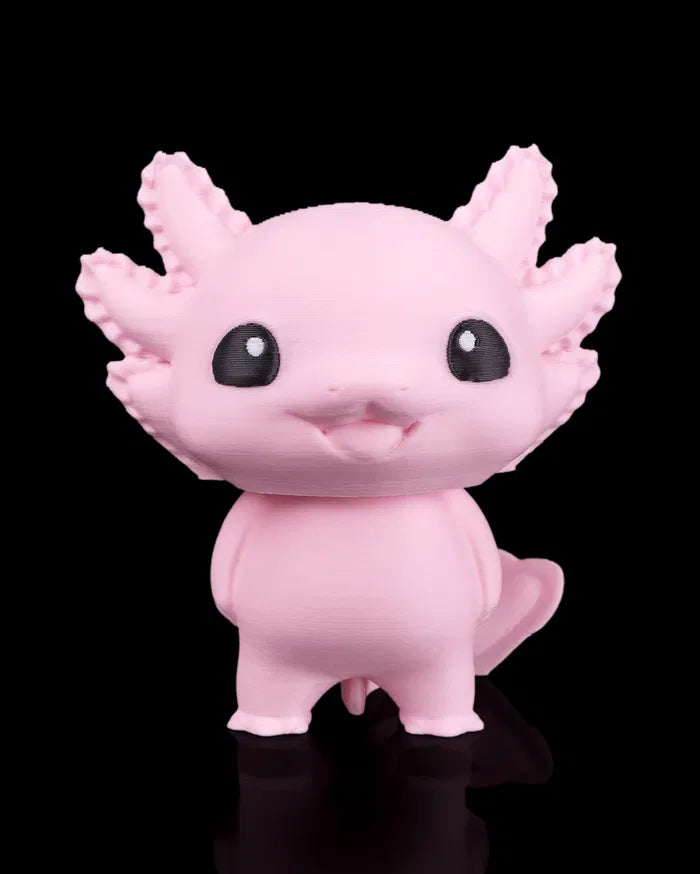 Pink axolotl figurine on a black background